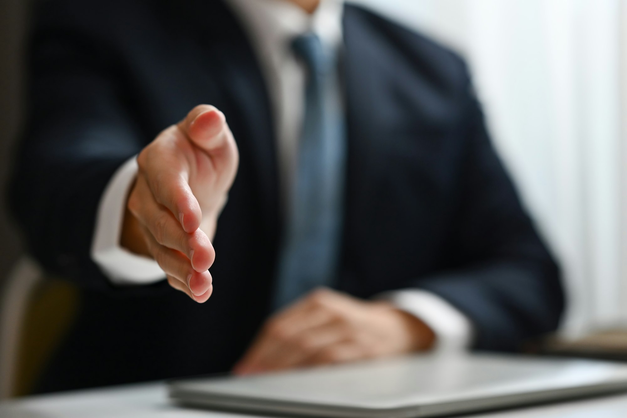 Professional businessman, hr recruiter extending hand for handshake at camera greeting or welcoming